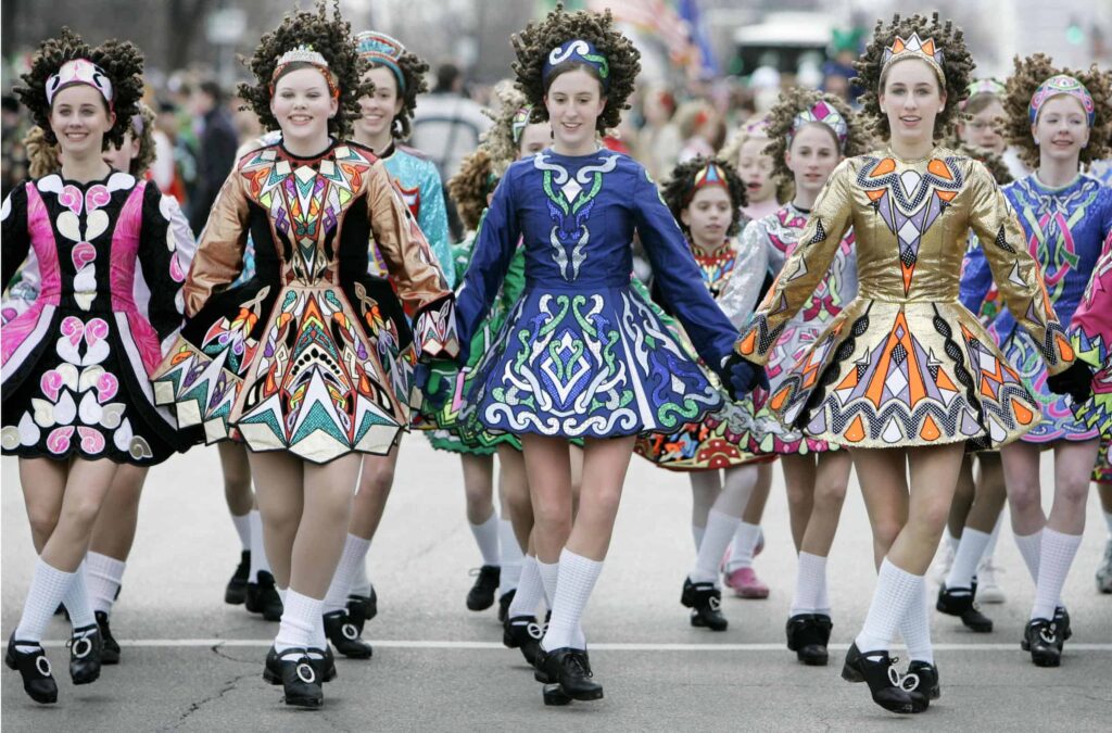 Girls performing traditional Irish dance in colorful costumes